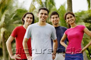 PictureIndia - Young adults standing in park, looking at camera