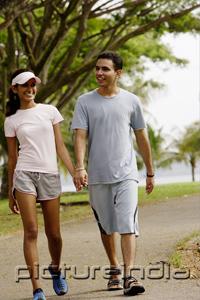 PictureIndia - Couple walking hand in hand, smiling