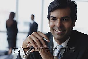 PictureIndia - Businessman smiling at camera
